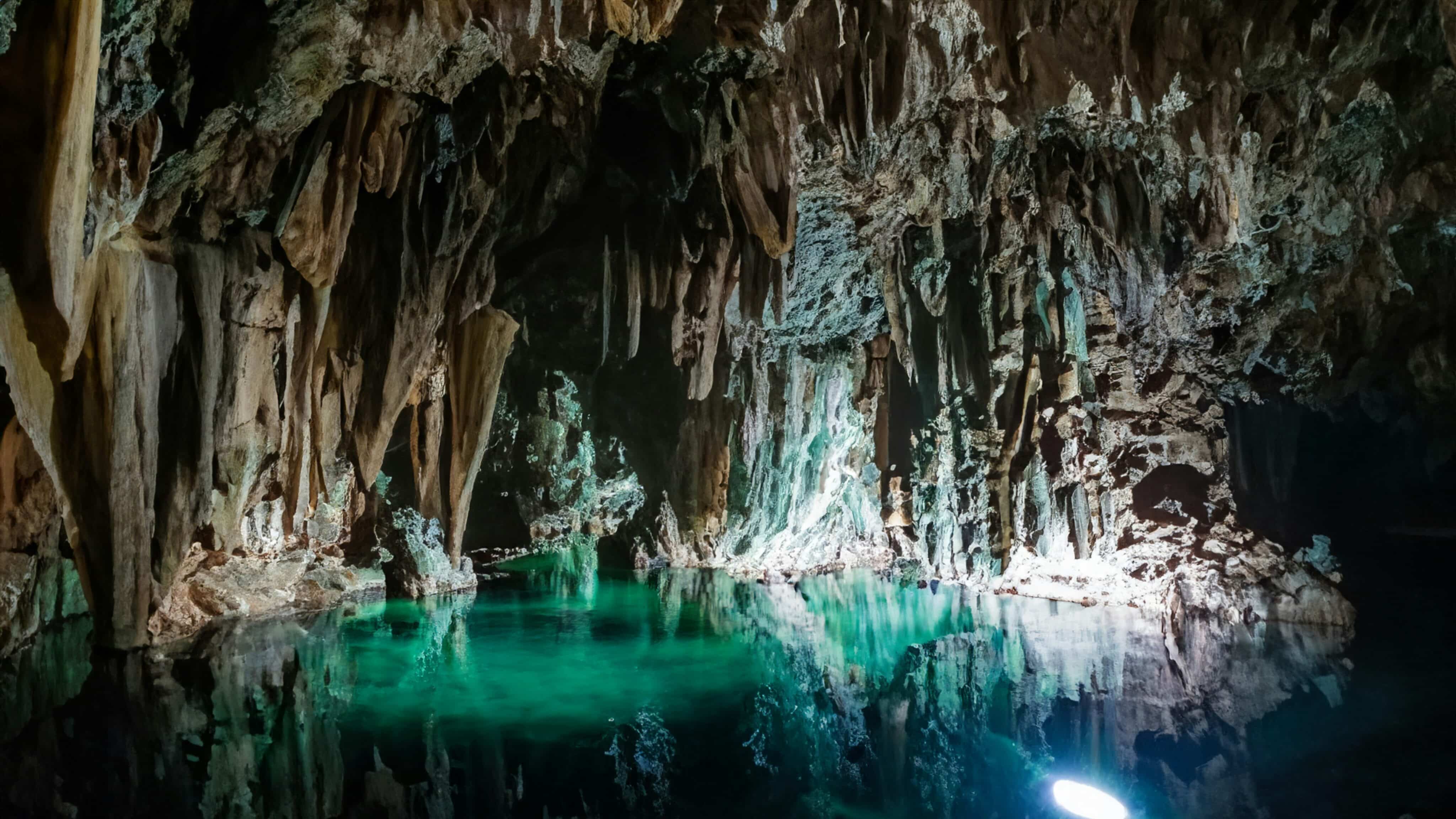 a cave filled with lots of green water